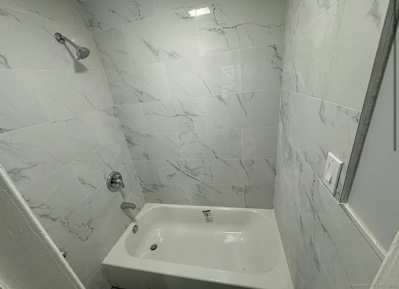 85 Caroline Street, Unit 1R Bridgeport, CT 06608 - Photo 3 of 3 a bathroom with a white bath tub and a shower