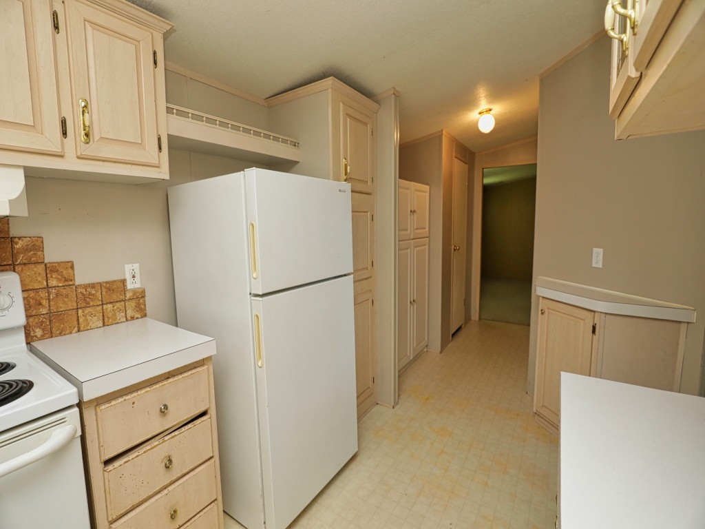 210 Floyd Street Boling, TX 77420 - Photo 17 of 29 a kitchen with refrigerator cabinets and wooden floor