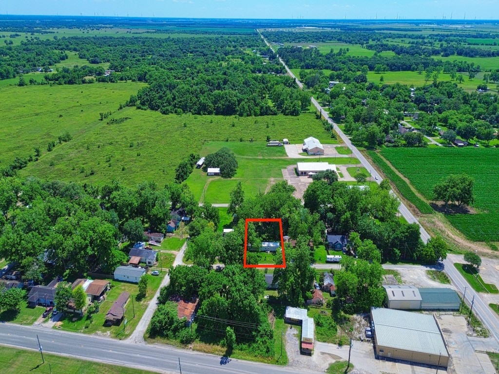 210 Floyd Street Boling, TX 77420 - Photo 2 of 29 a view of a city with lush green forest