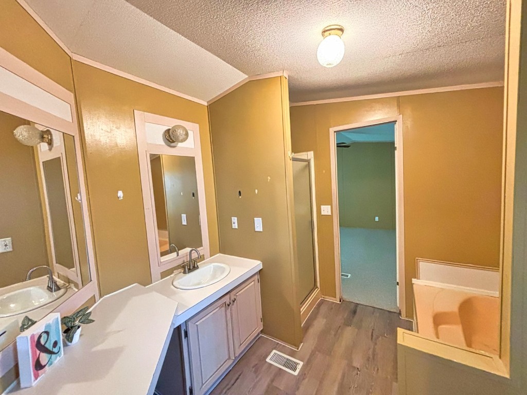 210 Floyd Street Boling, TX 77420 - Photo 23 of 29 a bathroom with a double vanity sink a mirror and a shower