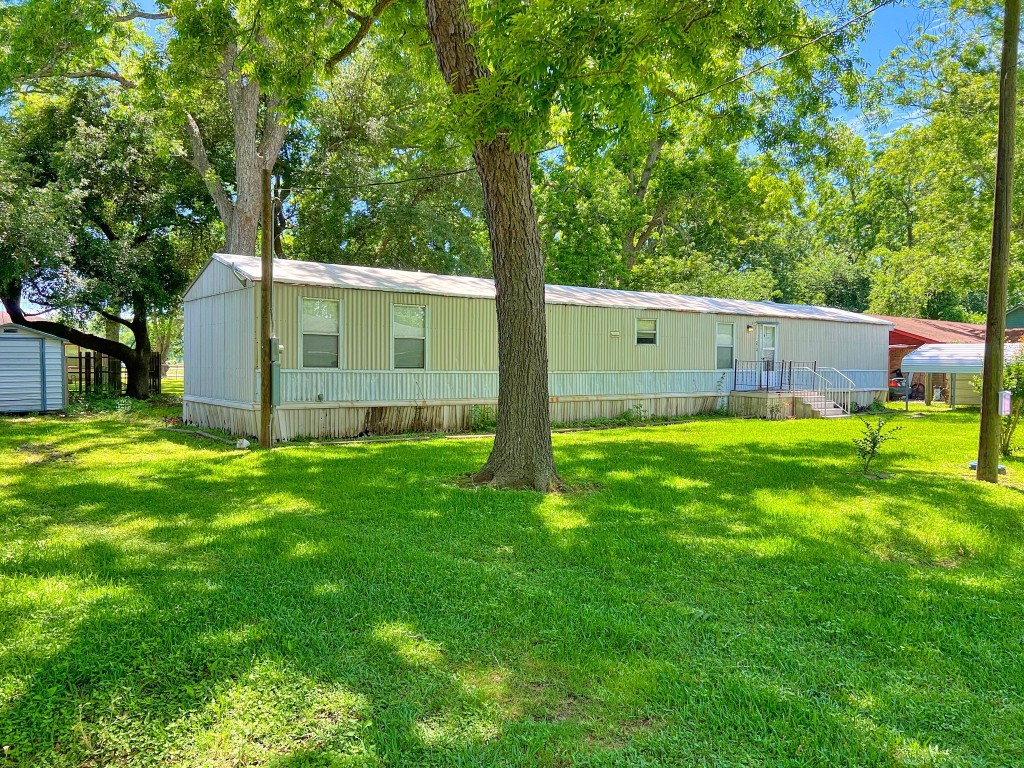210 Floyd Street Boling, TX 77420 - Photo 6 of 29 a view of backyard with a small cabin