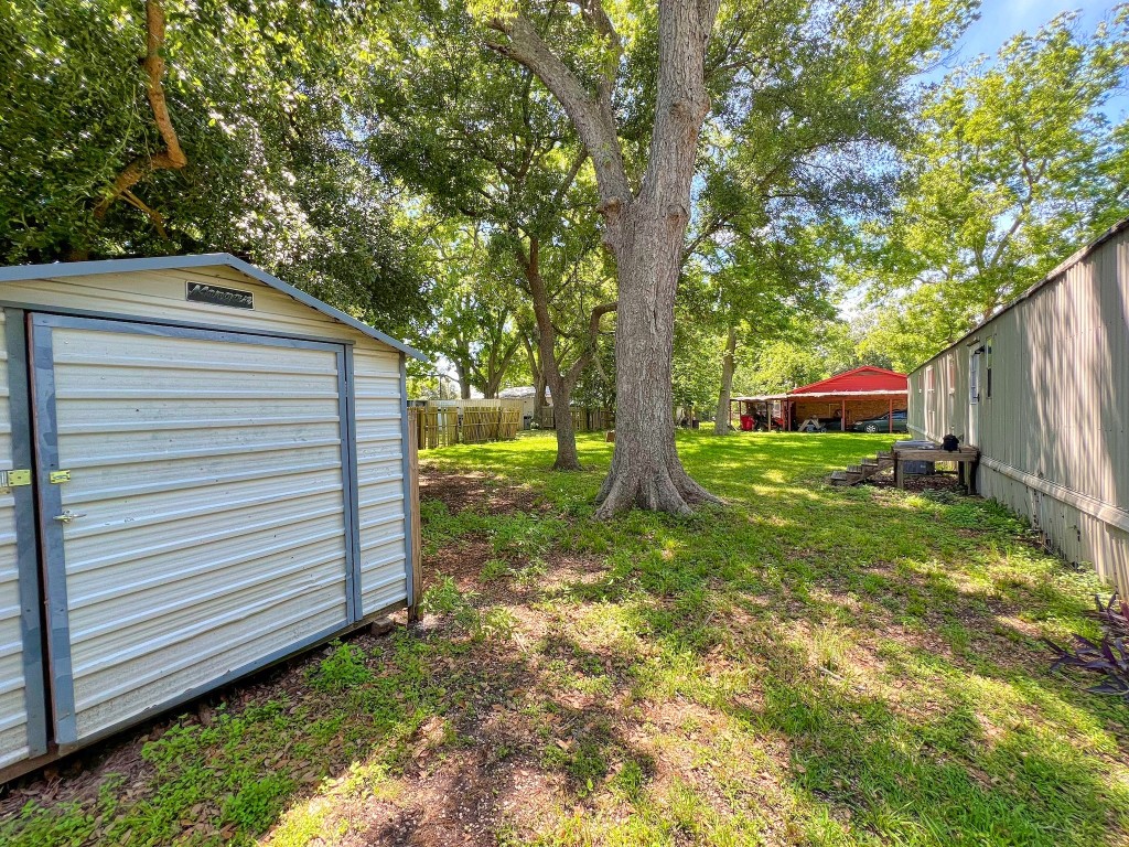 210 Floyd Street Boling, TX 77420 - Photo 9 of 29 a view of a backyard with a tree