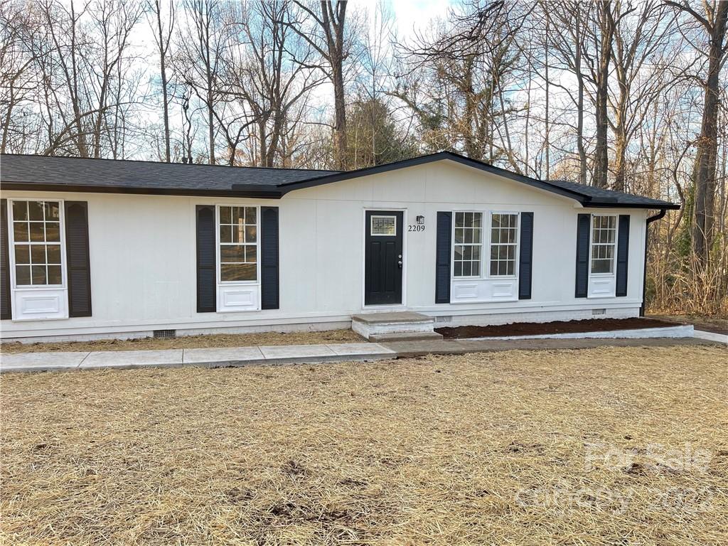 2209 Sunset Boulevard Charlotte, NC 28269 - Photo 1 of 17 a house with trees in the background