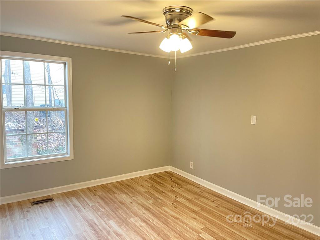 2209 Sunset Boulevard Charlotte, NC 28269 - Photo 15 of 17 a view of empty room with wooden floor and fan