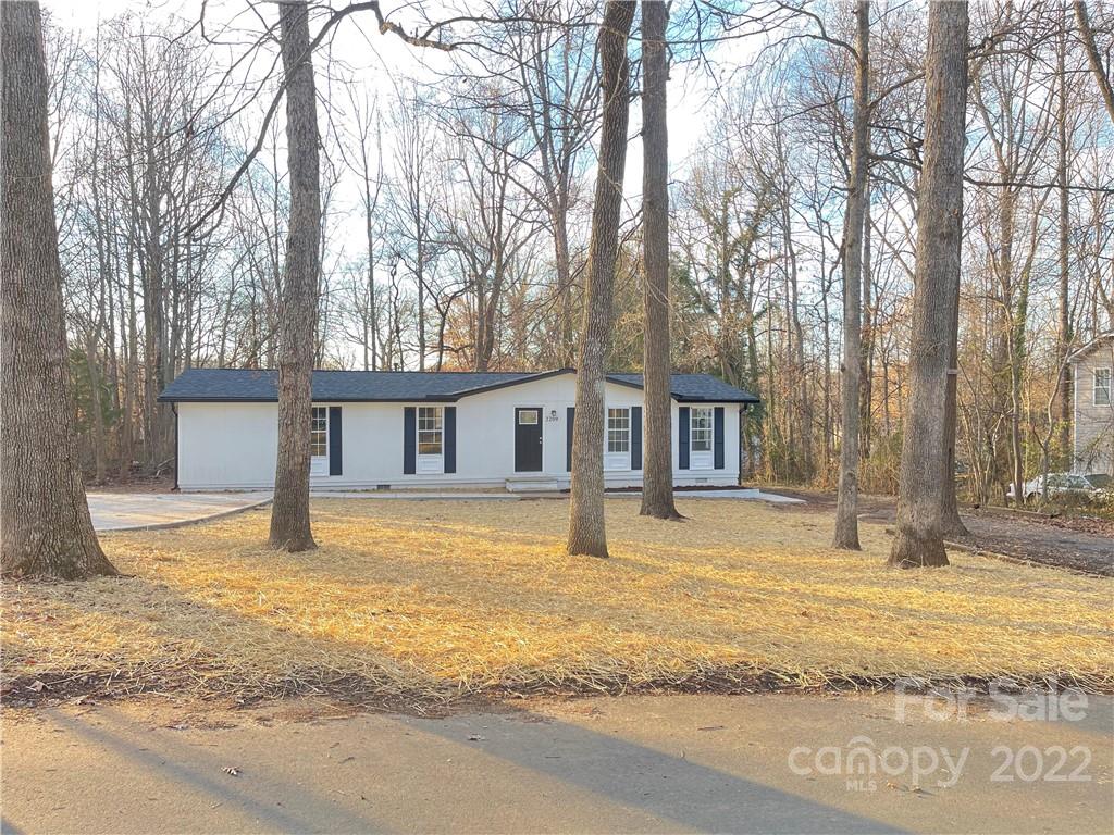 2209 Sunset Boulevard Charlotte, NC 28269 - Photo 3 of 17 a front view of a house with a yard covered with snow
