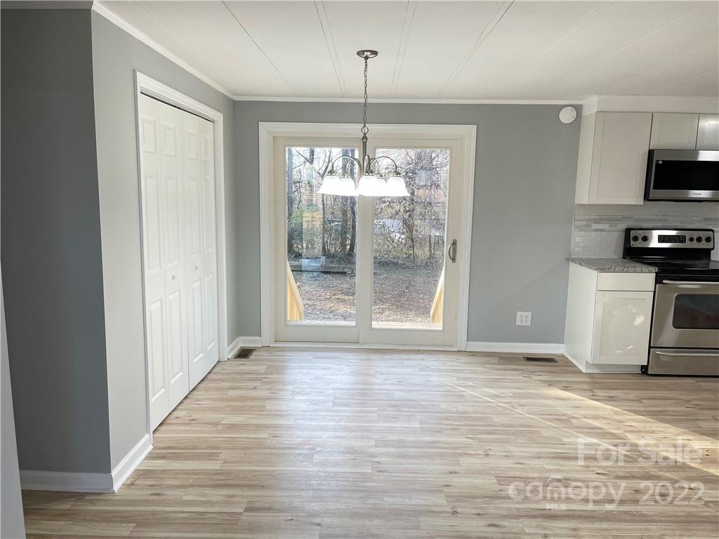2209 Sunset Boulevard Charlotte, NC 28269 - Photo 4 of 17 a view of a kitchen with a sink wooden cabinets and a window