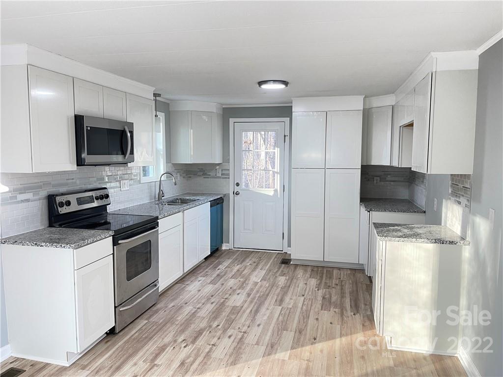 2209 Sunset Boulevard Charlotte, NC 28269 - Photo 5 of 17 a kitchen with a refrigerator stove and microwave