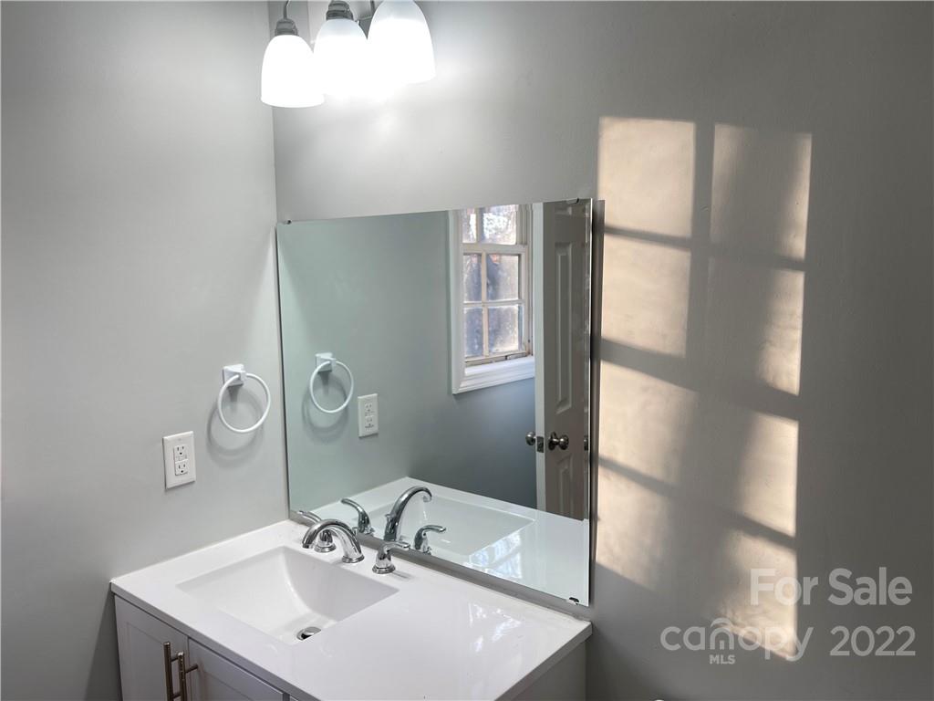 2209 Sunset Boulevard Charlotte, NC 28269 - Photo 6 of 17 a bathroom with a sink and a mirror