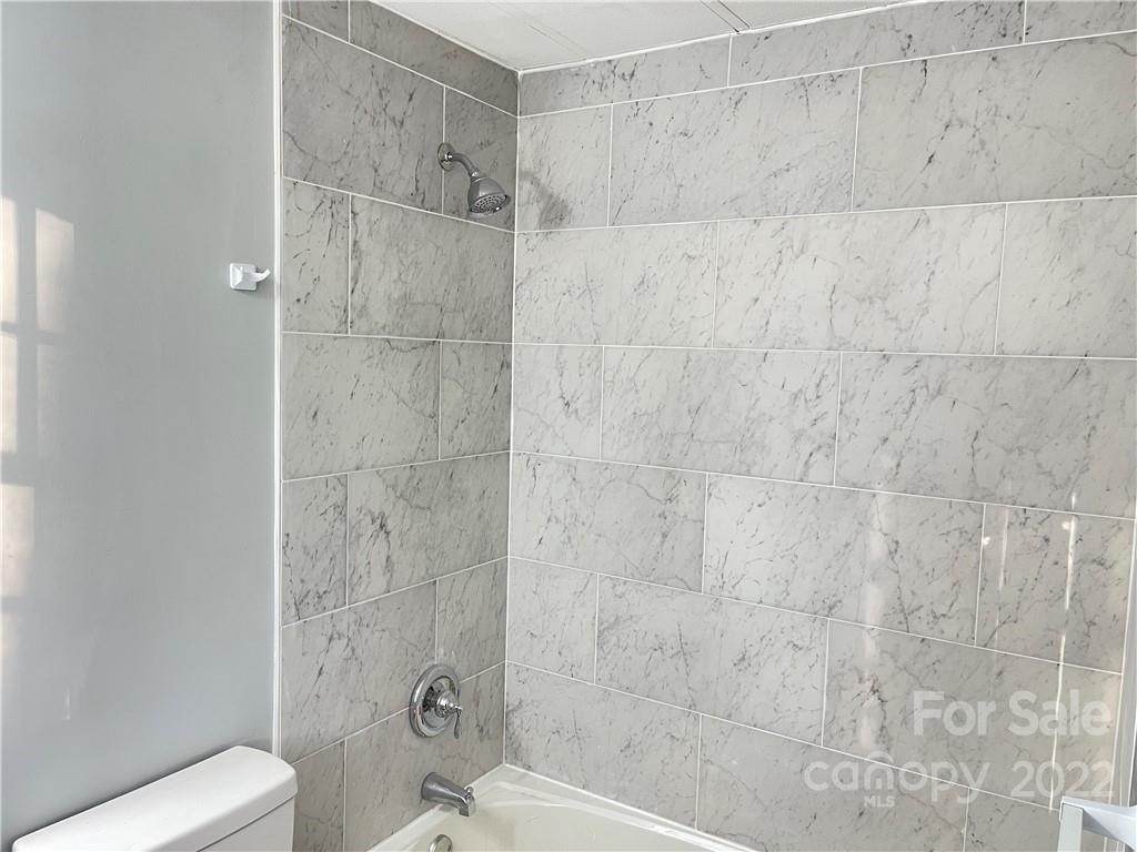 2209 Sunset Boulevard Charlotte, NC 28269 - Photo 7 of 17 a bathroom with a shower and a toilet