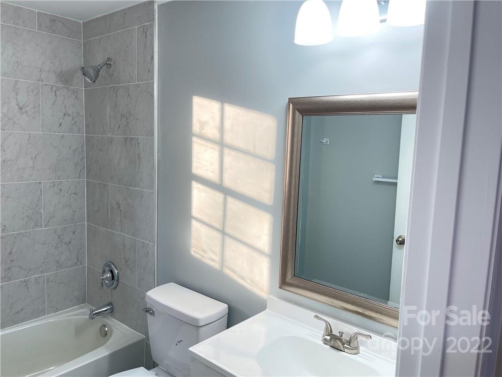 2209 Sunset Boulevard Charlotte, NC 28269 - Photo 8 of 17 a bathroom with a sink toilet and shower