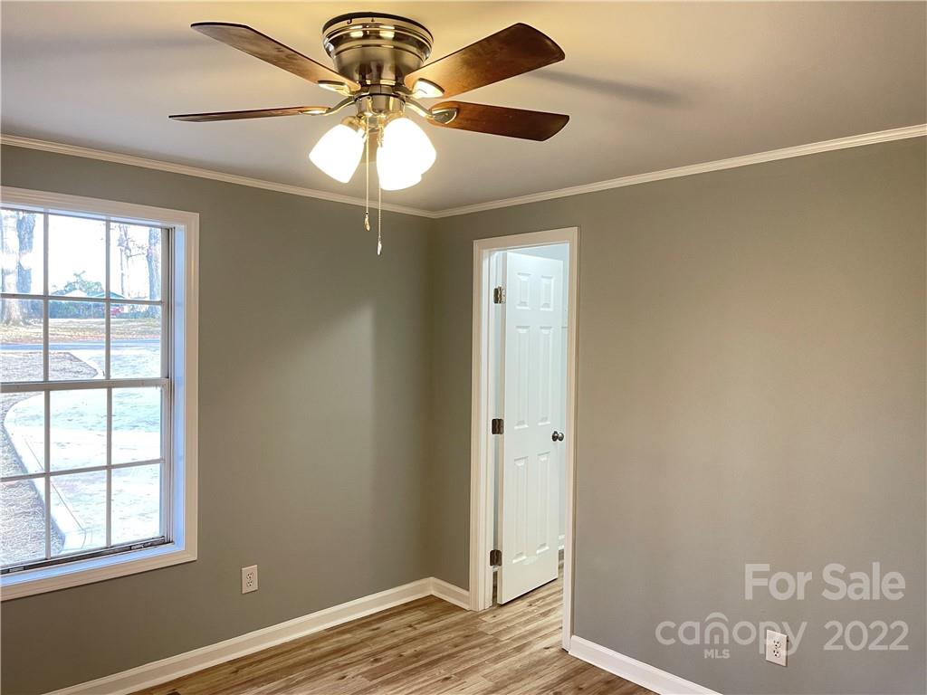2209 Sunset Boulevard Charlotte, NC 28269 - Photo 9 of 17 a view of an empty room with window and wooden floor