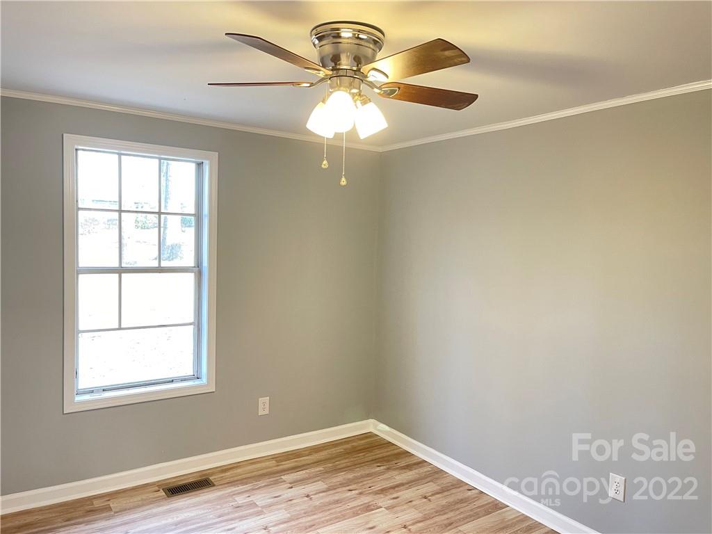 2209 Sunset Boulevard Charlotte, NC 28269 - Photo 10 of 17 wooden floor in an empty room with a window