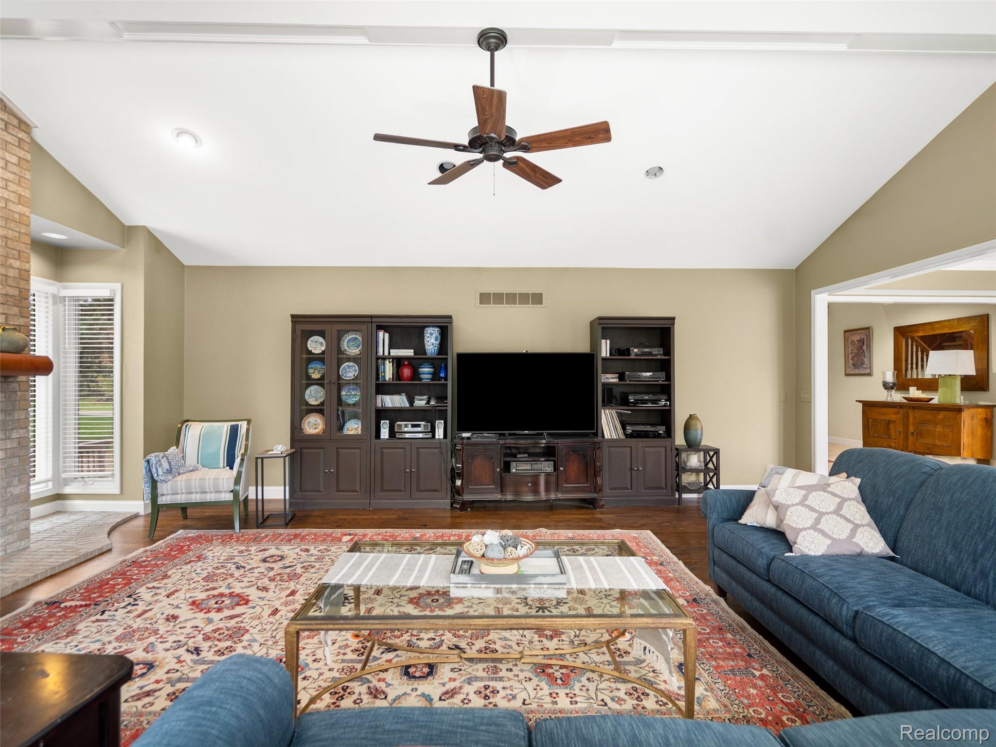 5724 Murfield Drive Rochester, MI 48306 - Photo 63 of 99 Living area featuring vaulted ceiling, a ceiling fan, and wood finished floors