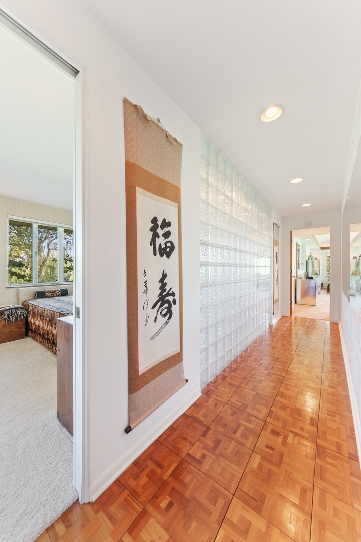 126 Brinker Road Barrington Hills, IL 60010 - Photo 13 of 31 a view of a hallway with wooden floor and a living room