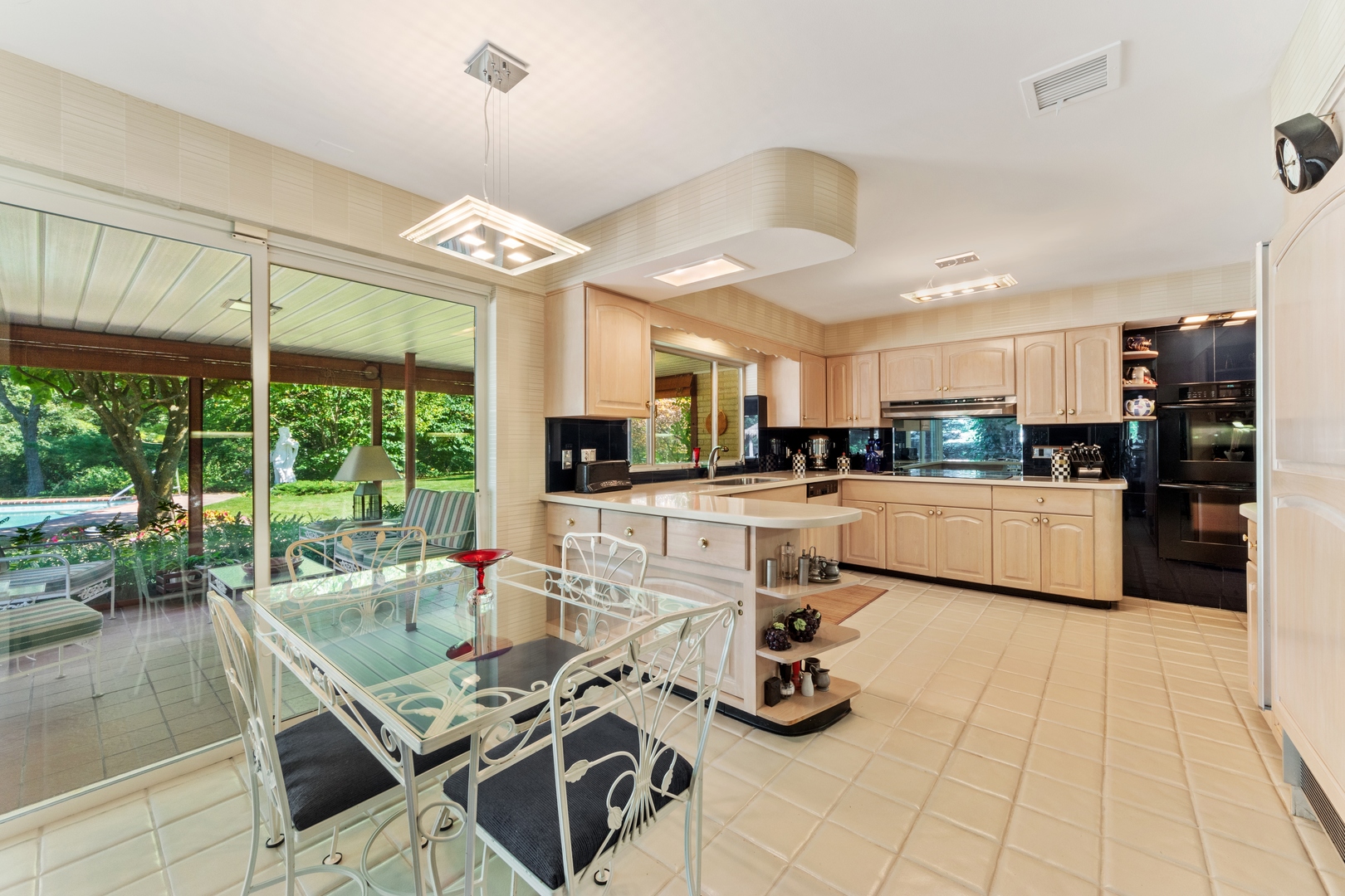126 Brinker Road Barrington Hills, IL 60010 - Photo 7 of 31 a kitchen with stainless steel appliances kitchen island granite countertop a stove and white cabinets
