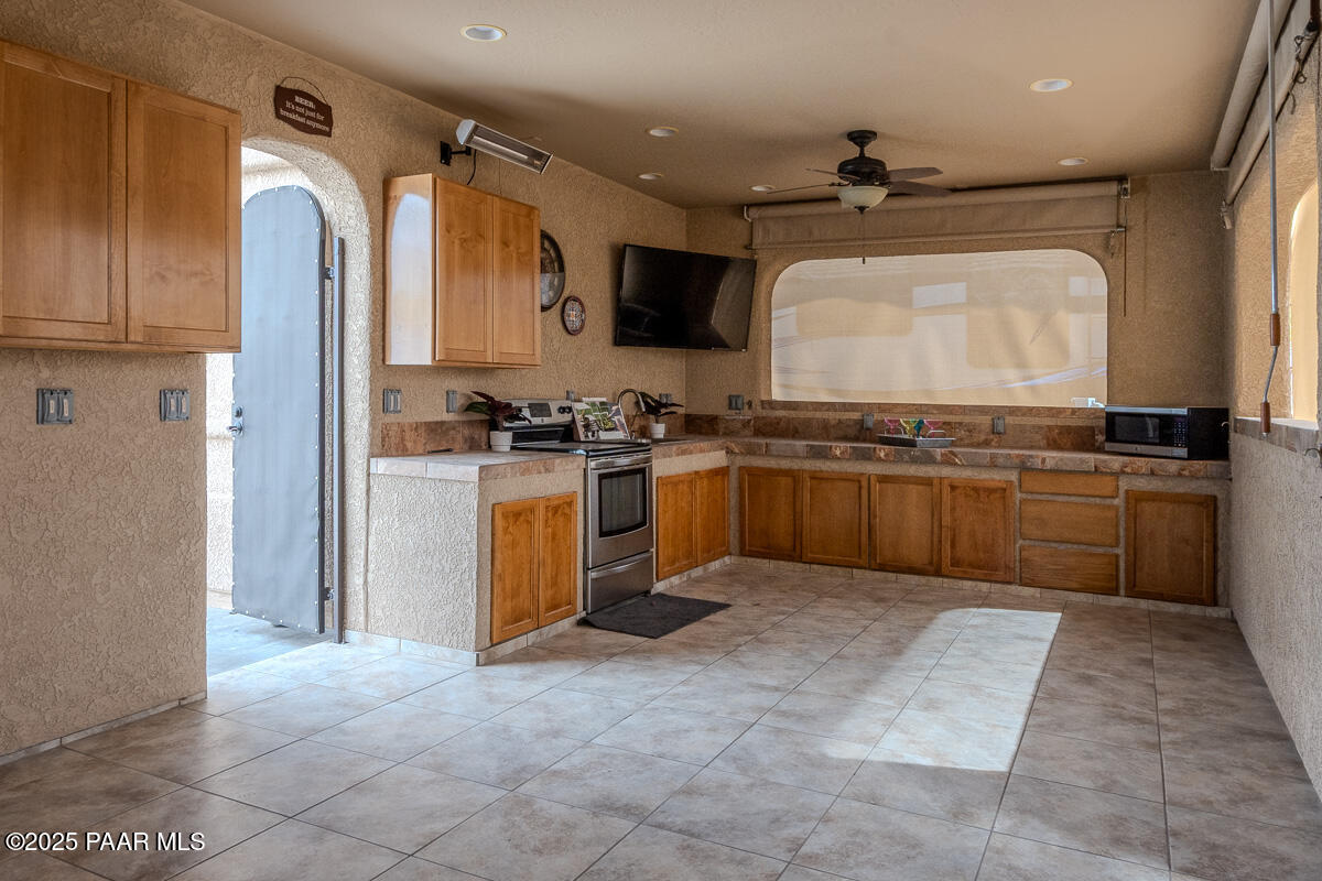 1905 Victoria Farms Road Lake Havasu City, AZ 86404 - Photo 5 of 22 a kitchen with stainless steel appliances granite countertop a stove sink and cabinets