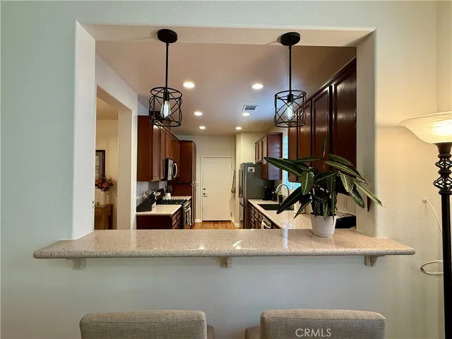 a view of a kitchen with sink and appliances