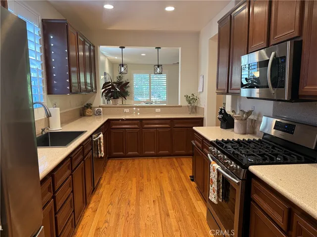 a kitchen with kitchen island granite countertop a sink stove and cabinets