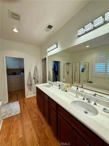 a spacious bathroom with a granite countertop sink and a mirror