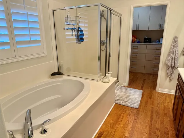 a bathroom with a tub a sink and a shower