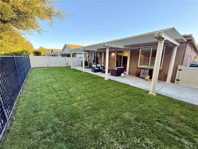 a view of a house with backyard porch and sitting area