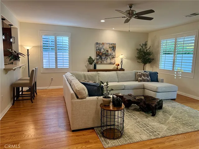 a living room with furniture and wooden floor