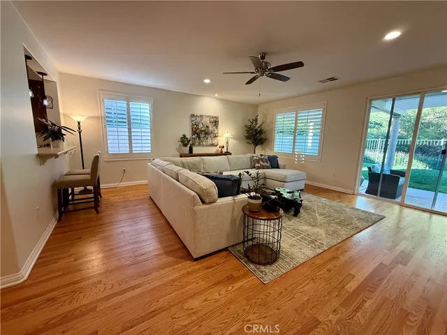 a living room with furniture window and wooden floor