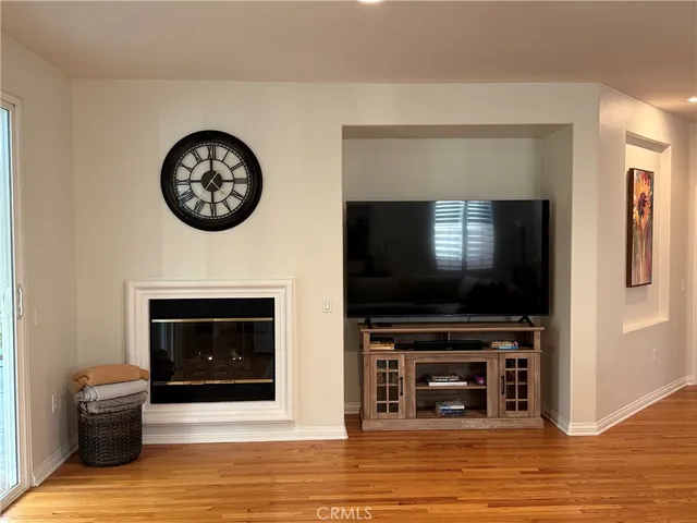 a living room with a fireplace and a flat screen tv