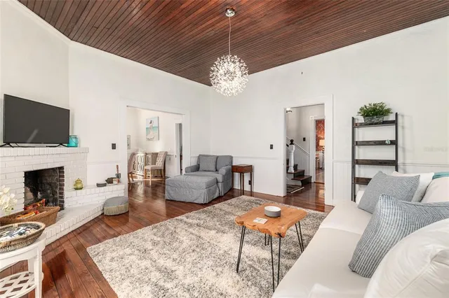 a view of a dining room with furniture wooden floor and chandelier