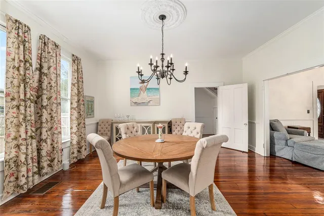 a kitchen with cabinets stainless steel appliances and wooden floor