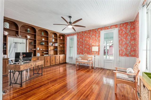 a view of a kitchen with furniture and wooden floor
