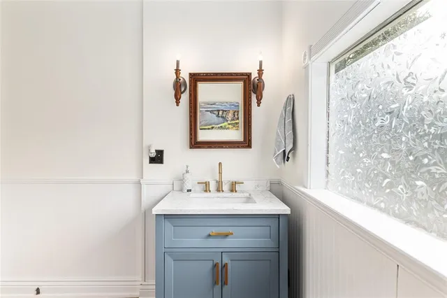 a spacious bedroom with a bed and wooden floor