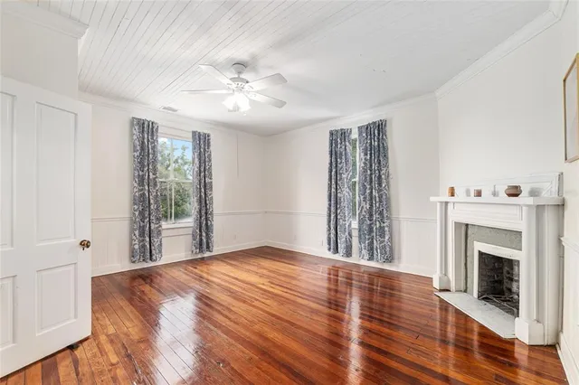 a view of a house with a small yard and wooden fence