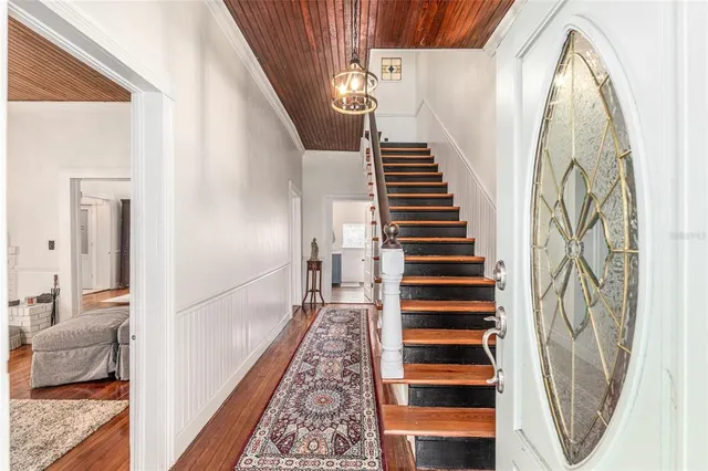 a living room with furniture a fireplace and a chandelier