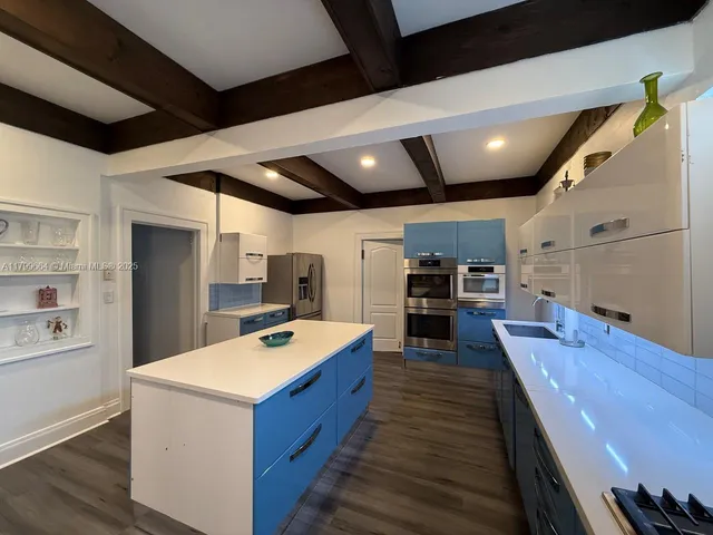 a kitchen with sink and cabinets