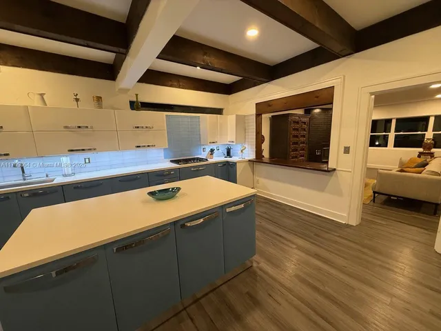 a kitchen with a sink and a stove top oven