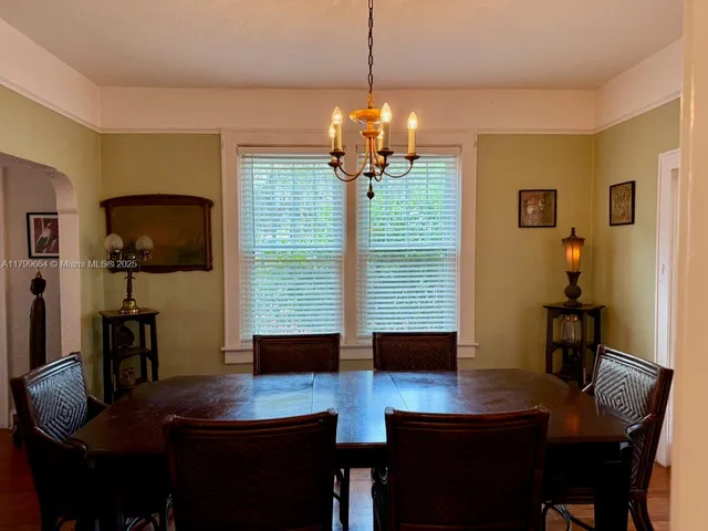 a view of a dining room with furniture and chandelier