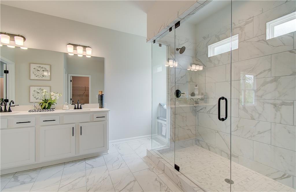 31 Butternut Way Auburn, GA 30011 - Photo 21 of 35 a bathroom with a shower sink and mirror
