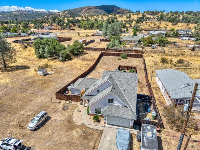 an aerial view of a house with outdoor space