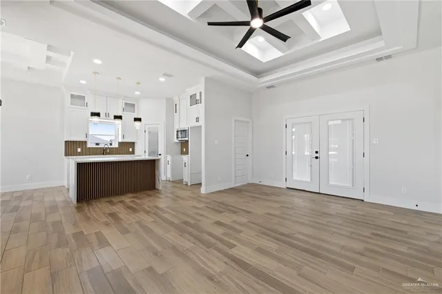 a view of kitchen with refrigerator and window