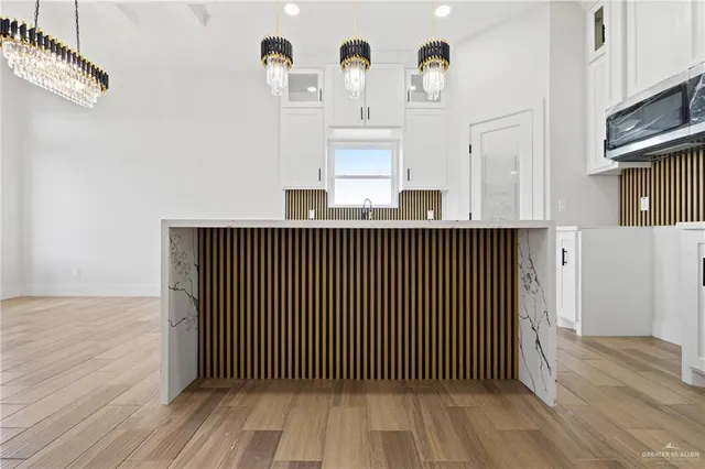 a view of a room with wooden floor