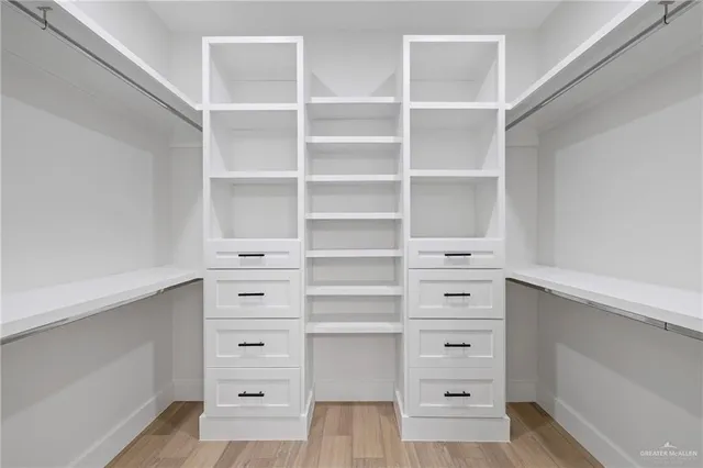 a view of walk in closet with empty racks