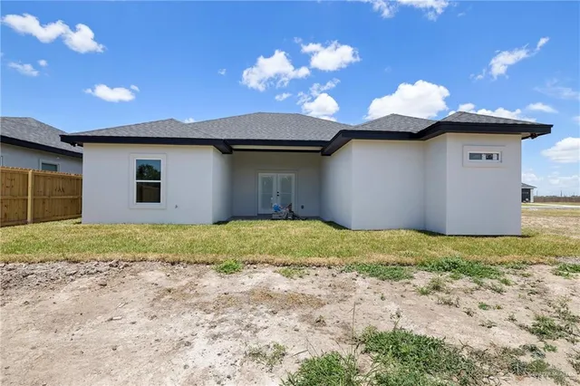 a view of a house with a backyard