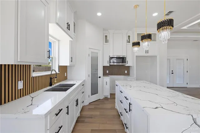 a kitchen with kitchen island white cabinets and refrigerator