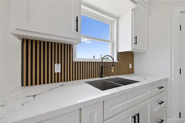 a utility room with dryer and stairs