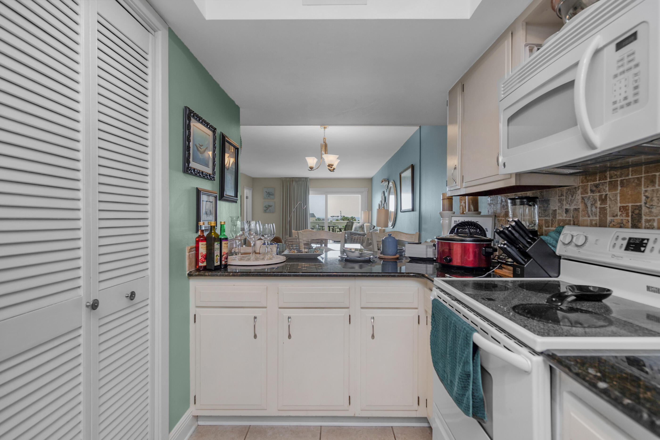909 Santa Rosa Boulevard, Unit 241 Fort Walton Beach, FL 32548 - Photo 11 of 28 a kitchen with a sink cabinets and a stove top oven