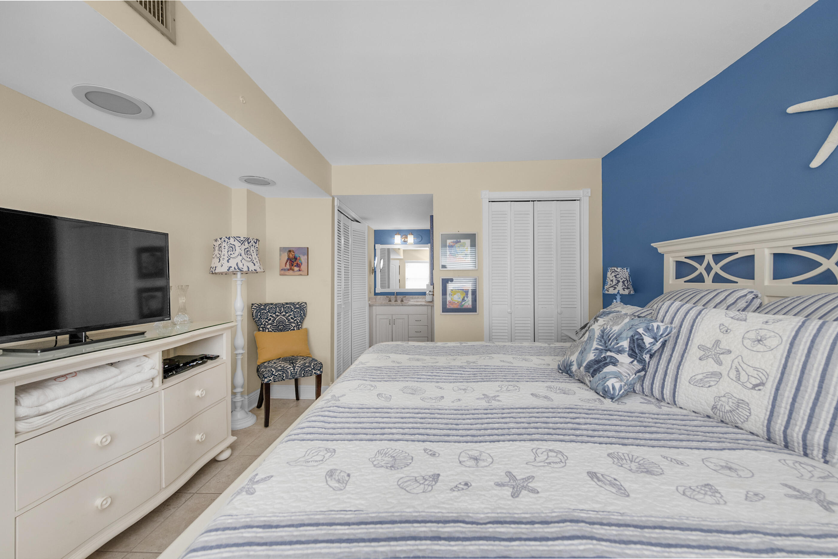 909 Santa Rosa Boulevard, Unit 241 Fort Walton Beach, FL 32548 - Photo 13 of 28 a bedroom with a bed and flat screen tv