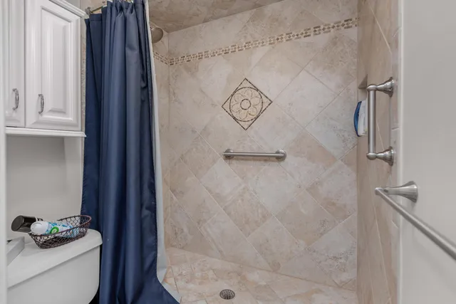 a bathroom with a shower toilet and sink