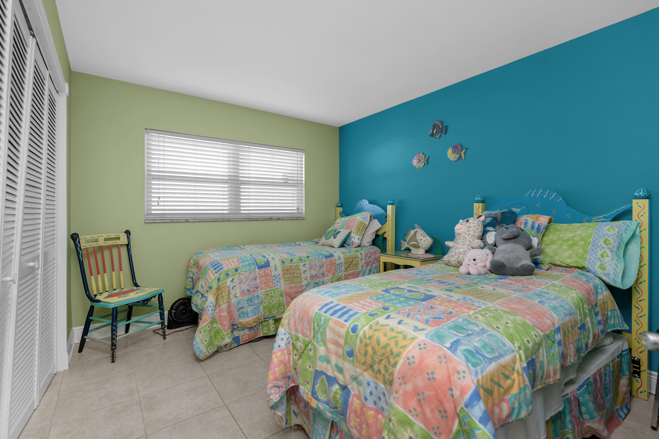 909 Santa Rosa Boulevard, Unit 241 Fort Walton Beach, FL 32548 - Photo 18 of 28 a bedroom with two beds and a chair