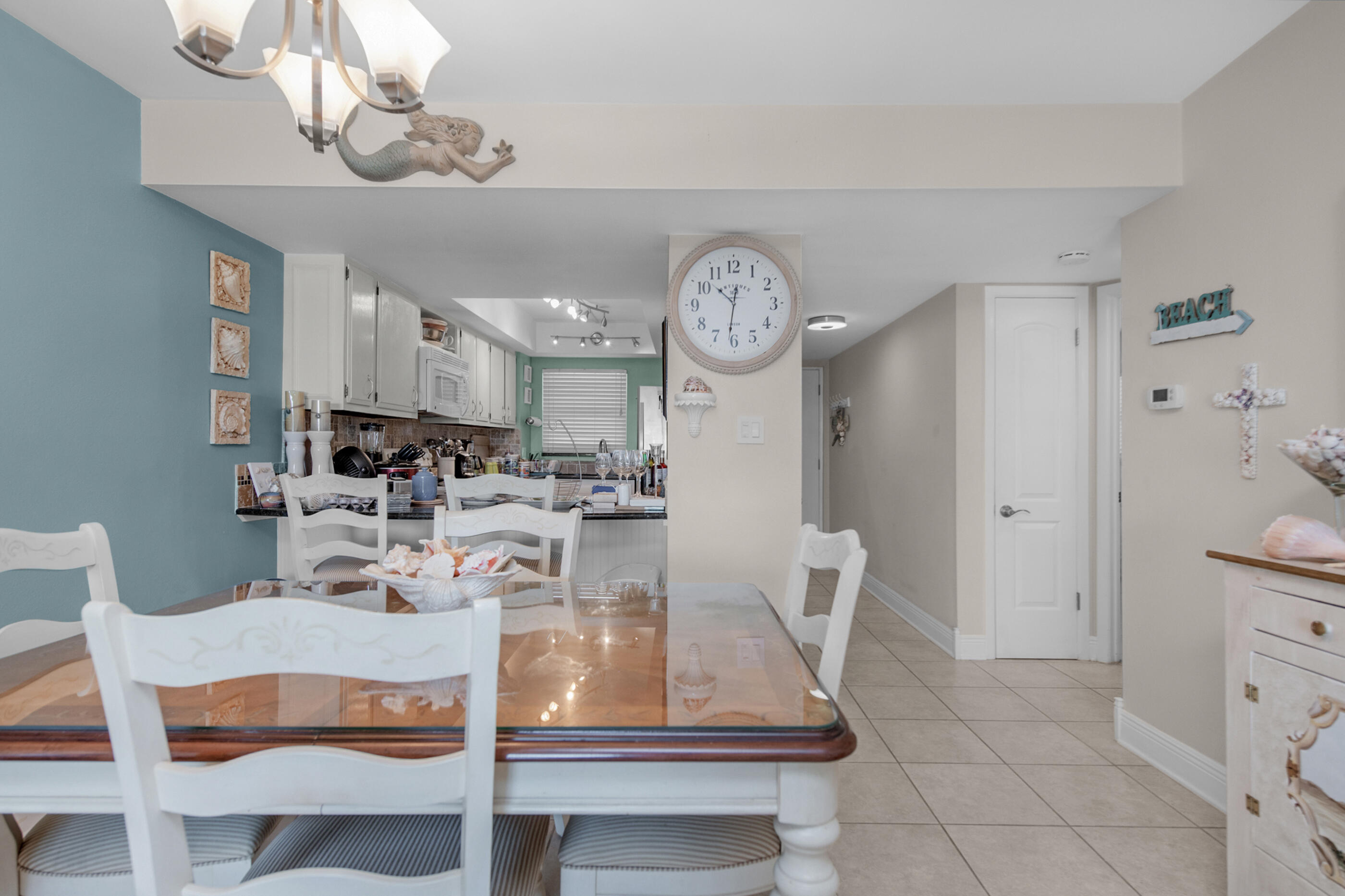 909 Santa Rosa Boulevard, Unit 241 Fort Walton Beach, FL 32548 - Photo 3 of 28 a view of a dining room and livingroom with furniture wooden floor and a chandelier